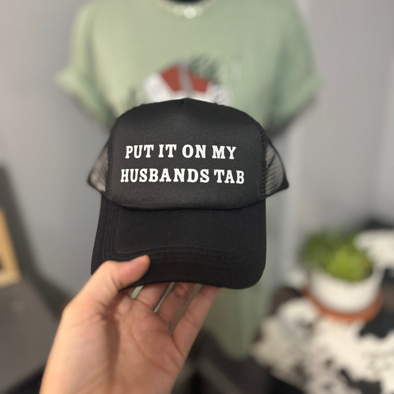 Put it on my husbands tab Trucker Hat